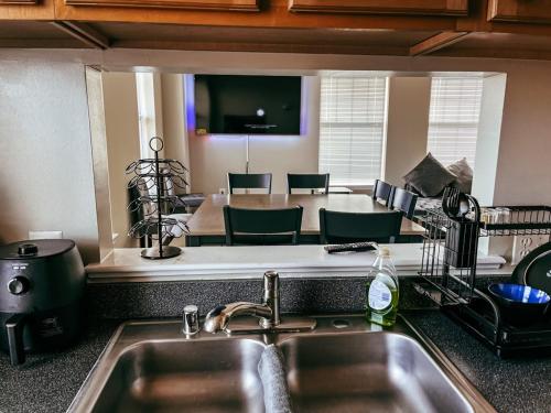 a kitchen with a sink and a table with chairs at Luxury penthouse apartment in Baltimore