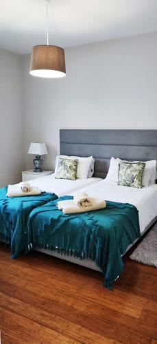 a bedroom with two beds with towels on them at Formosa Ocean View - 142109/AL in Funchal