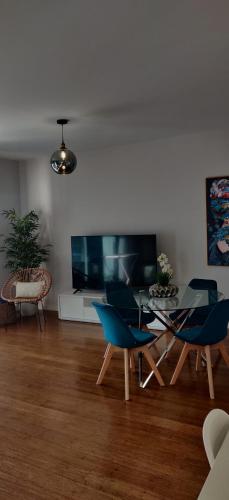 a living room with blue chairs and a table at Formosa Ocean View - 142109/AL in Funchal