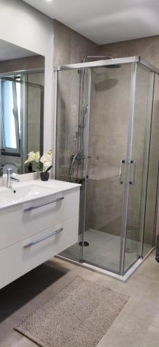 a bathroom with a glass shower and a sink at Formosa Ocean View - 142109/AL in Funchal
