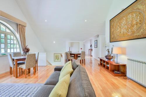 a living room with a couch and a table at Morgado - River Suites and Houses by PCH in Padrões