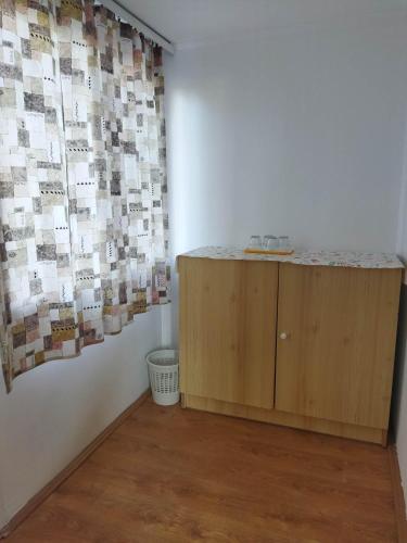 a room with a counter and a wall with photographs at Mecsek Virágai Lak in Magyarhertelend