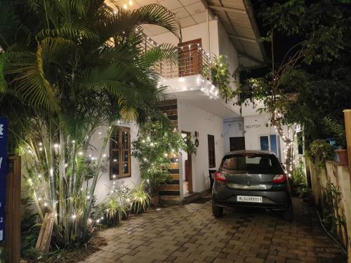 a car parked in front of a building at White Shore Beach Homestay in Alleppey