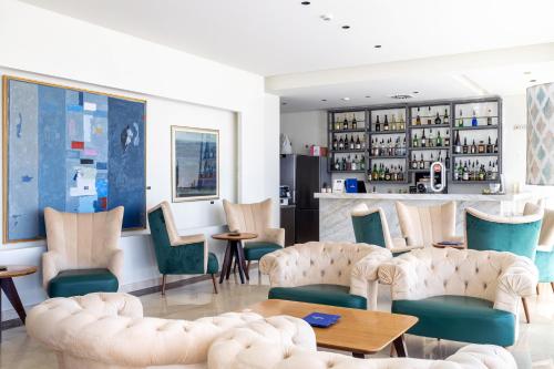 a restaurant with chairs and tables and a bar at Oporto Airport & Business Hotel in Maia