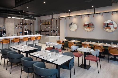 a restaurant with tables and chairs and a bar at Residence Inn by Marriott Manchester Piccadilly in Manchester