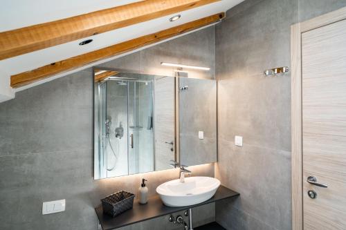 a bathroom with a sink and a shower at Bacan Serviced Apartments in Cavtat