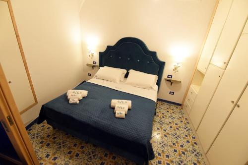 a bedroom with a large bed with two pillows at Casa De Rosa in Atrani
