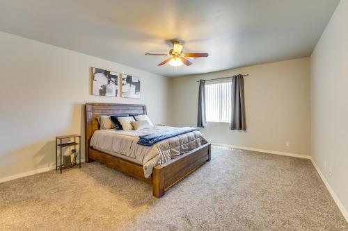 a bedroom with a bed and a ceiling fan at Beautiful Bullhead City Home Rental with Yard! in Bullhead City