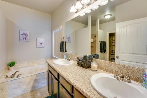 a bathroom with two sinks and a large mirror at Beautiful Bullhead City Home Rental with Yard! in Bullhead City