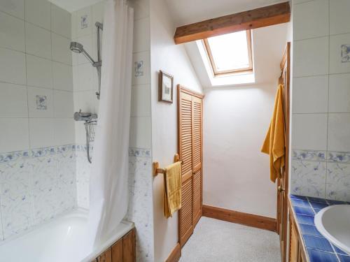 a bathroom with a shower and a sink at The Cottage in Stratford-upon-Avon