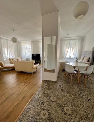 a living room with a couch and a table at Palác Daun - Studio Apartments in Znojmo