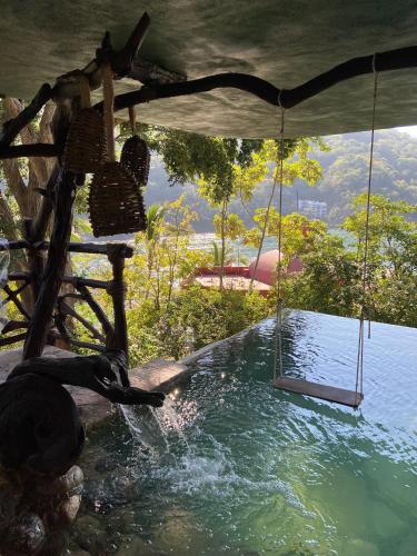 a swing in a pool of water with a view at Villa Lala Boutique Hotel Adults Only in Puerto Vallarta
