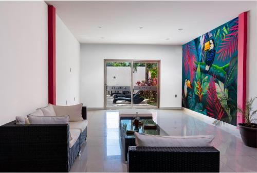 a living room with a large painting on the wall at Hotel Ambra in Playa del Carmen