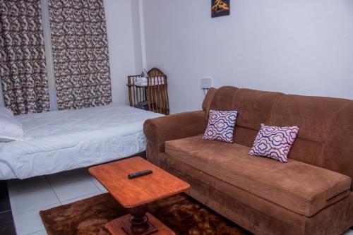 a living room with a couch and a coffee table at Rainbow apartment in Mombasa