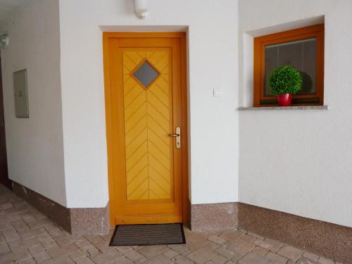 a wooden door on a building with a window at Apartment Jalps 2 in Bohinj