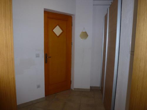 a hallway with a wooden door in a room at Apartment Jalps 2 in Bohinj