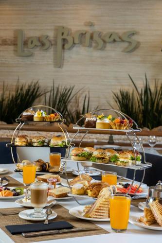 a table topped with plates of food and drinks at Enjoy Punta del Este in Punta del Este