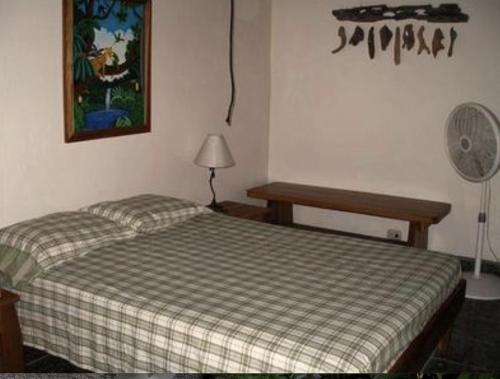 a bedroom with two beds and a fan at Piscina Natural on the Sea in Cahuita