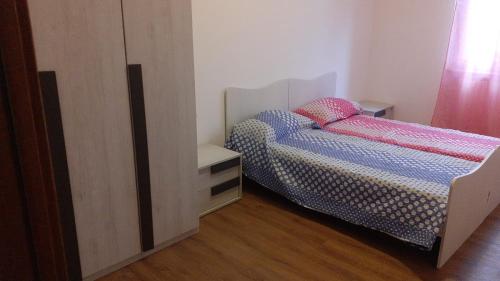 a bedroom with two beds and a dresser at Casa Lina in Novate Mezzola