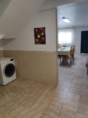 a living room with a washing machine and a table at HOUSEMARIA in Nazaré