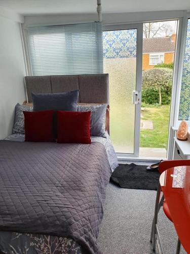 a bedroom with a bed and a large window at Richfieldsat59 in Milton Keynes