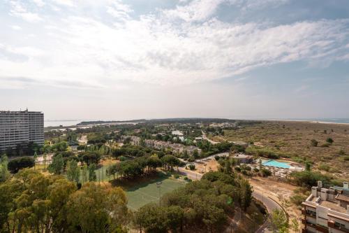 an aerial view of a city with a lake at Aqualuz Troia Mar by The Editory in Troia