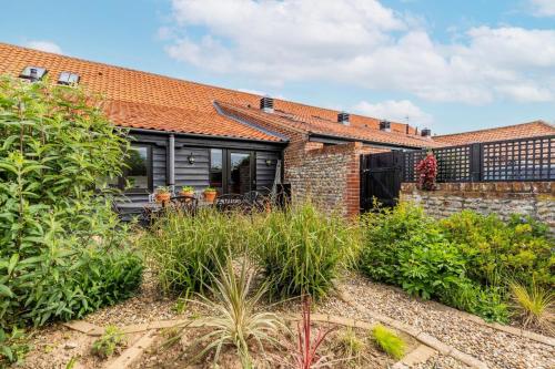 a brick house with an orange roof at Nicholson Cottage in Happisburgh