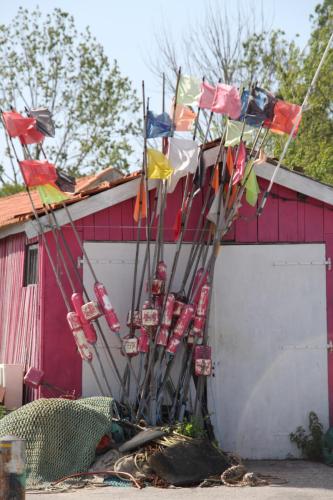 a group of flags hanging off the side of a building at Face aux Flots in La Cotinière