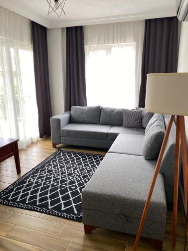 a living room with a couch and a rug at KAŞ MERKEZ İMREN APART 1 in Kas