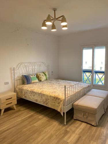 a bedroom with a bed and a window and a ceiling at 4 bedroom twin house in Mountain View Ras El Hekma near the North Coast in Sīdī ‘Abd ar Raḩmān