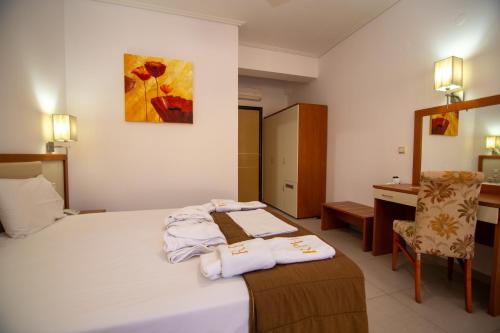 a hotel room with a bed with towels on it at Riviera Perdika Hotel in Perdika