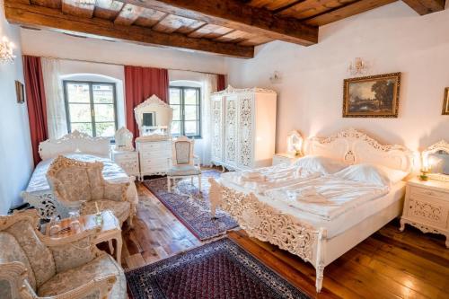 a bedroom with white furniture and a large bed at Leylaria in Český Krumlov