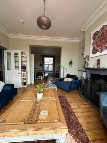 a living room with a coffee table and a couch at Zen House By The Sea In Margate in Kent