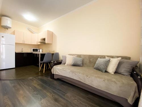 a living room with a couch and a kitchen at Lux appartment, Comfort town, Kiev in Kyiv