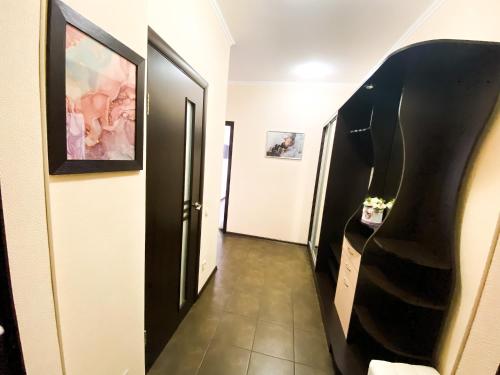 a hallway with black and white doors and a stairway at Lux appartment, Comfort town, Kiev in Kyiv