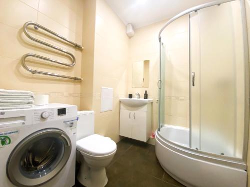 a bathroom with a toilet and a washing machine at Lux appartment, Comfort town, Kiev in Kyiv