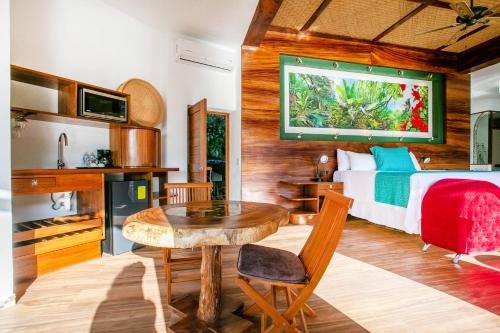 a bedroom with a bed and a table in a room at Villa Lala Boutique Hotel Adults Only in Puerto Vallarta