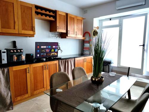 a kitchen with a glass table and a dining room at Holiday - Malta Balluta Beach in Sliema
