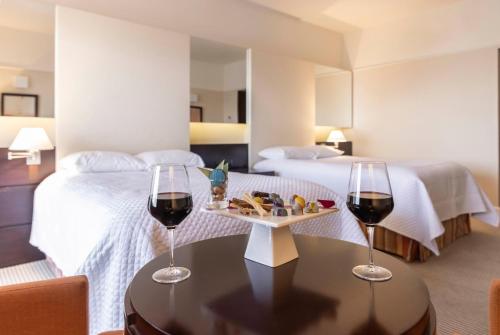 two glasses of wine on a table in a hotel room at Enjoy Punta del Este in Punta del Este