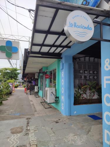 a building with a sign that reads la nordada at La Hacienda Rooms & Food in Jacó