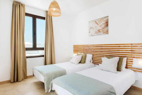 Postel nebo postele na pokoji v ubytování Villa Lyra Piscina Climatizada