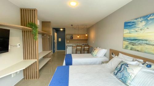a hotel room with two beds and a kitchen at Costa Solar Lagoa in Florianópolis