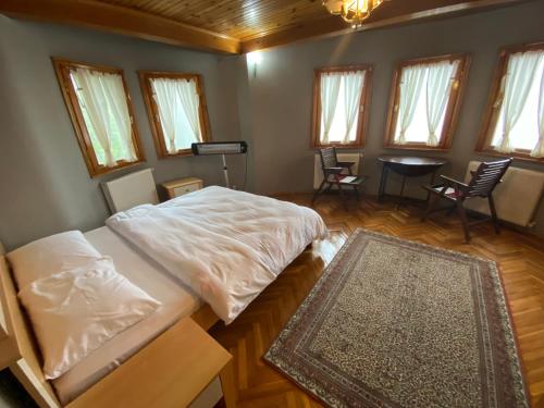 a bedroom with two beds and a table and chairs at Çiftlik in Arsin