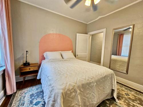 a bedroom with a large bed with an orange headboard at Cute stay in Memphis in Memphis