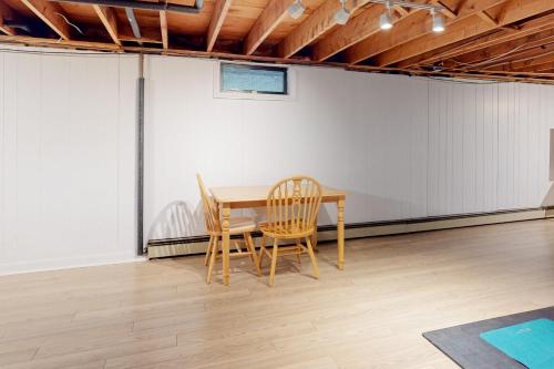 a table and two chairs in an empty room at Casco Breeze in North Harpswell