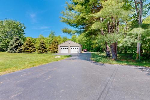 a driveway with a garage on the side of a house at Casco Breeze in North Harpswell