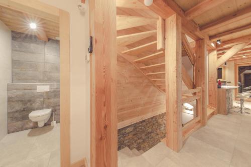 a bathroom with a staircase in a wooden house at Chalet la Rocca in La Chapelle-dʼAbondance
