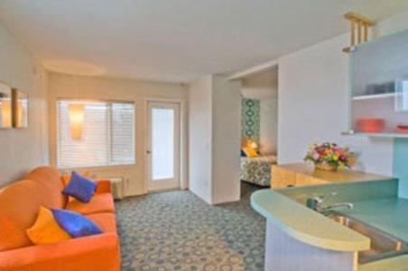 a living room with an orange couch and a kitchen at The StarLux in Wildwood