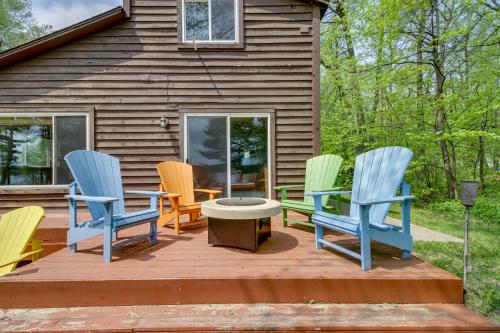 four chairs and a table on a deck in front of a house at Minnesota Cabin with Deck and Private Beach in Merrifield