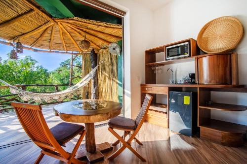 a dining room with a table and chairs and a window at Villa Lala Boutique Hotel Adults Only in Puerto Vallarta